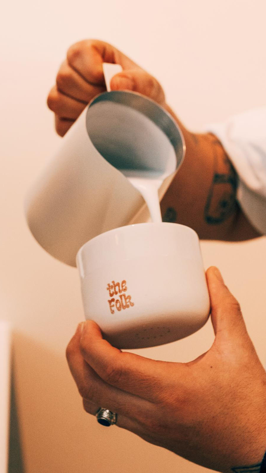 photo of pouring milk into a customized the folk cup