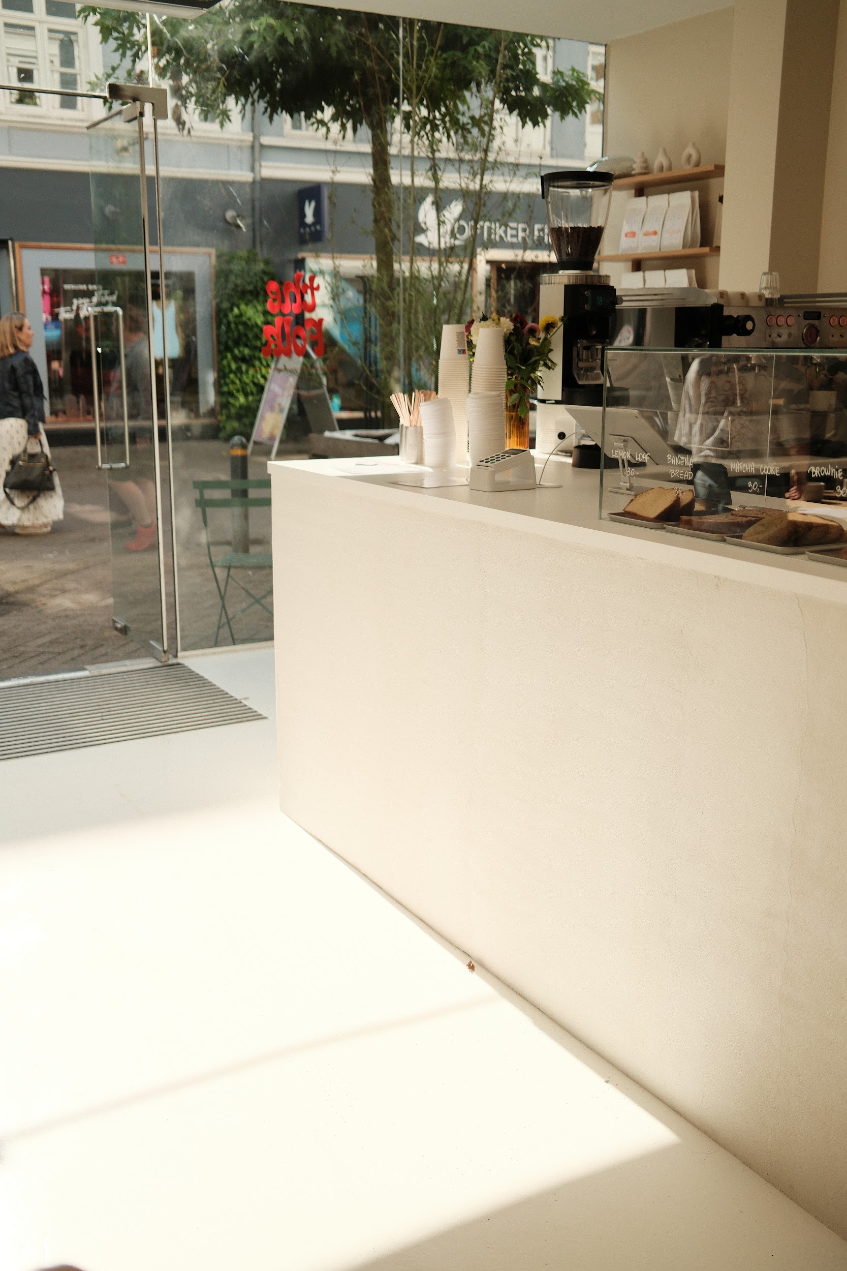 bright coffee shop interior showing bar and view on the street